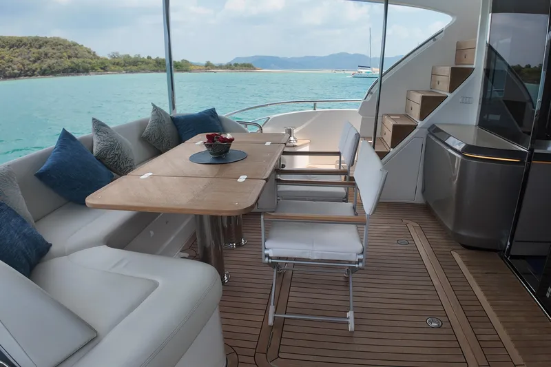 La Mer Yacht Photos Pics Luxurious 2023 Princess Y72 yacht deck with elegant seating and scenic ocean view.