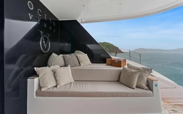 Ocean Vibes Yacht Photos Pics Luxurious Sunreef 70 yacht deck with comfortable seating, ocean view, and elegant design, 2020 model.