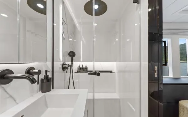 Ocean Vibes Yacht Photos Pics Luxurious bathroom in 2020 Sunreef 70 yacht with modern fixtures and glass shower.