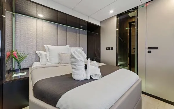 Ocean Vibes Yacht Photos Pics Luxurious bedroom interior on 2020 Sunreef 70 yacht, featuring elegant decor and plush bedding.