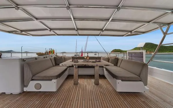 Ocean Vibes Yacht Photos Pics Luxurious Sunreef 70 yacht deck with spacious seating, 2020 model, overlooking serene ocean views.