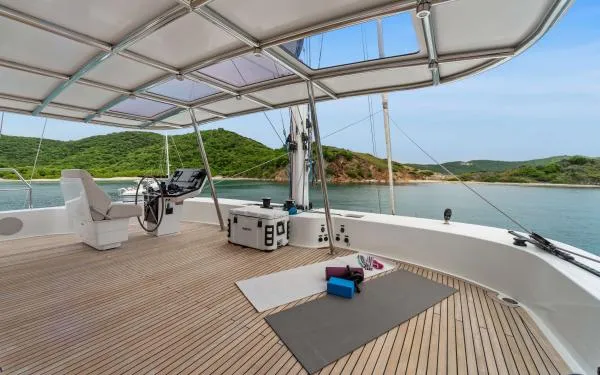 Ocean Vibes Yacht Photos Pics Spacious deck of 2020 Sunreef 70 yacht with yoga mats and scenic ocean view.