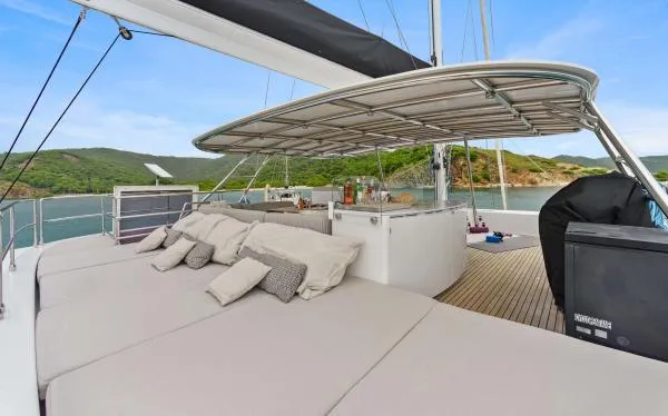 Ocean Vibes Yacht Photos Pics Luxurious Sunreef 70 yacht deck with sunbeds and scenic ocean view, 2020 model.
