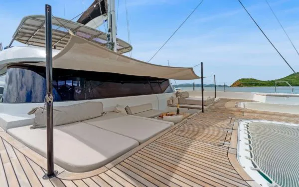 Ocean Vibes Yacht Photos Pics Luxurious Sunreef 70 yacht deck with sunbeds and canopy, 2020 model, ocean view.