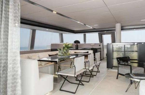 Ocean Vibes Yacht Photos Pics Luxurious interior of 2020 Sunreef 70 yacht with modern seating and panoramic windows.