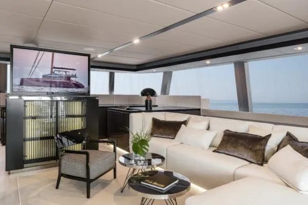 Ocean Vibes Yacht Photos Pics Luxurious interior of 2020 Sunreef 70 yacht with modern furnishings and ocean view.
