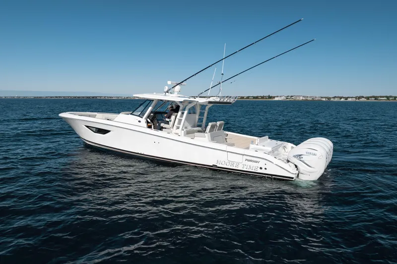 Moore Time Yacht Photos Pics 2023 Pursuit S 428 Sport boat on open water, clear sky, side view.