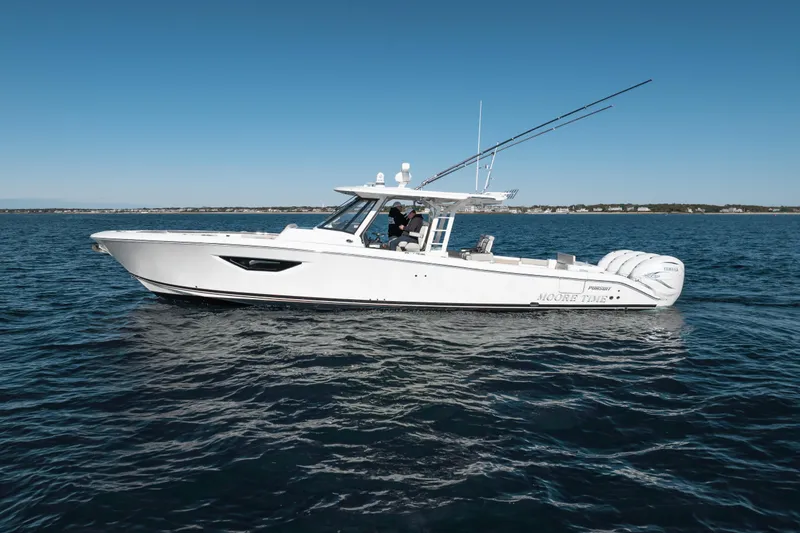 Moore Time Yacht Photos Pics 2023 Pursuit S 428 Sport boat cruising on open water under clear blue sky.