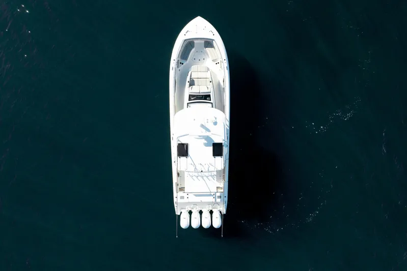 Moore Time Yacht Photos Pics Aerial view of 2023 Pursuit S 428 Sport boat on dark water.