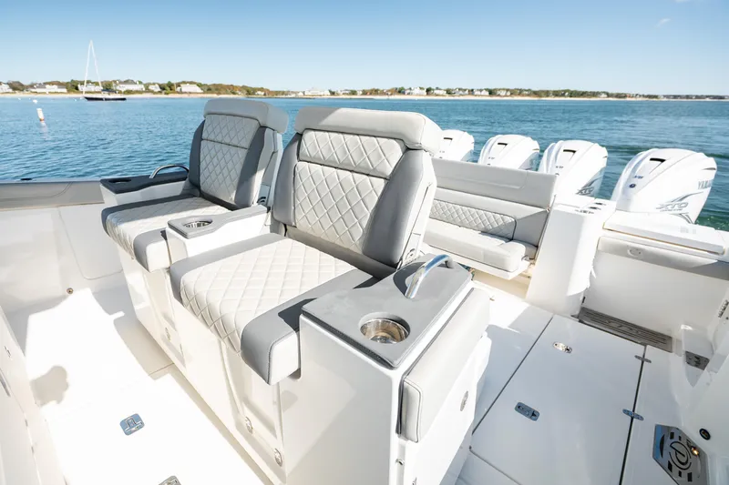 Moore Time Yacht Photos Pics 2023 Pursuit S 428 Sport boat interior with luxurious seating and multiple outboard engines.