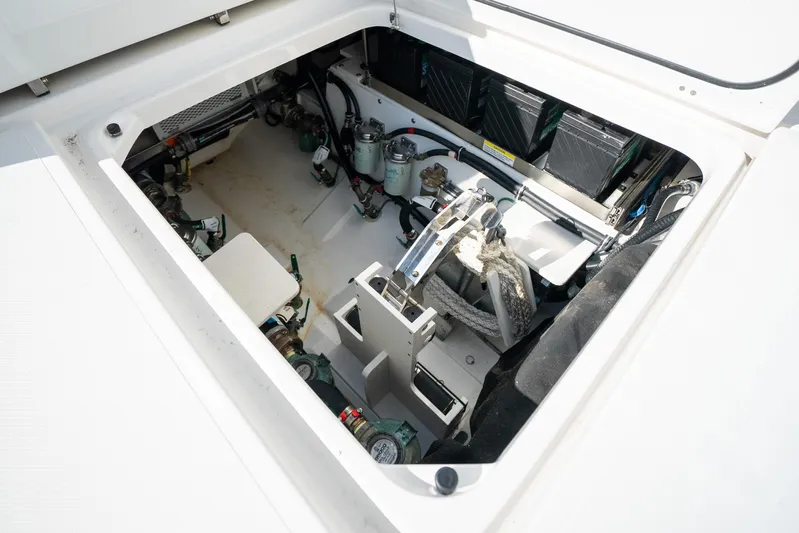 Moore Time Yacht Photos Pics 2023 Pursuit S 428 Sport boat engine compartment with mechanical components and wiring.