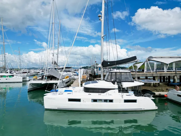 Promprang Yacht Photos Pics 2020 Lagoon 50 catamaran docked at marina under blue sky.