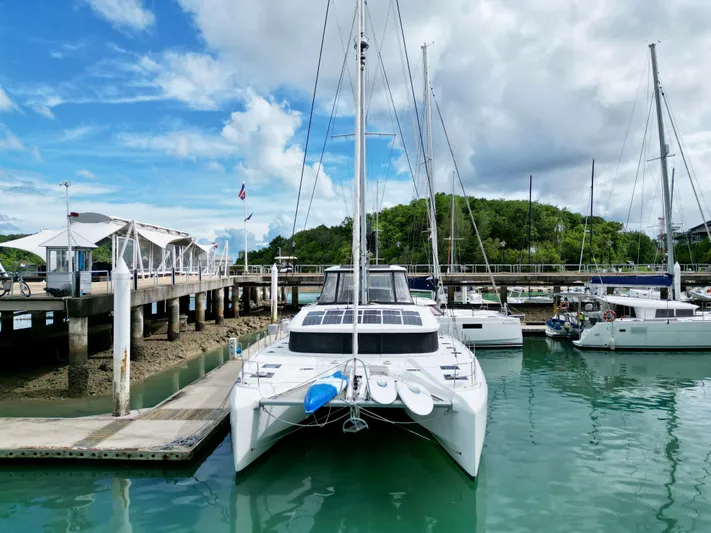 Promprang Yacht Photos Pics 2020 Lagoon 50 catamaran docked in a marina with clear skies and calm waters.
