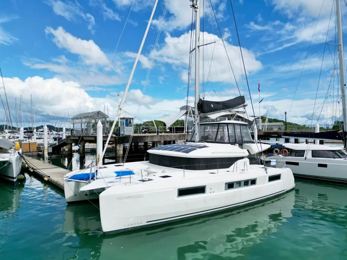 Promprang Yacht Photos Pics 2020 Lagoon 50 catamaran docked at marina under blue sky.