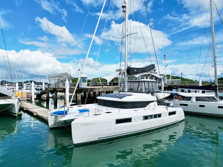 Promprang Yacht Photos Pics 2020 Lagoon 50 catamaran docked at marina under blue sky.