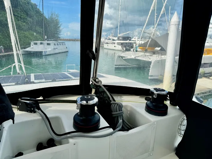 Promprang Yacht Photos Pics Cockpit view of a 2020 Lagoon 50 catamaran docked at a marina.