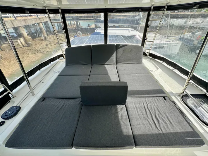 Promprang Yacht Photos Pics Spacious sunbathing area on 2020 Lagoon 50 catamaran with comfortable gray cushions.