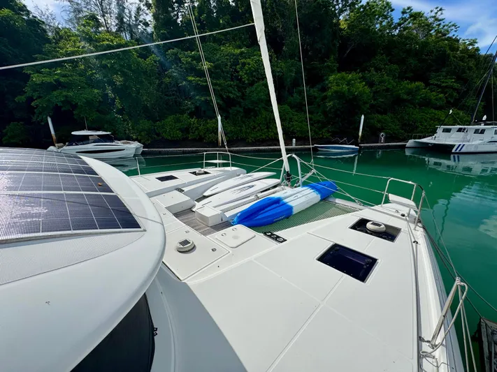 Promprang Yacht Photos Pics Lagoon 50 catamaran, 2020 model, docked in a serene marina with lush greenery.