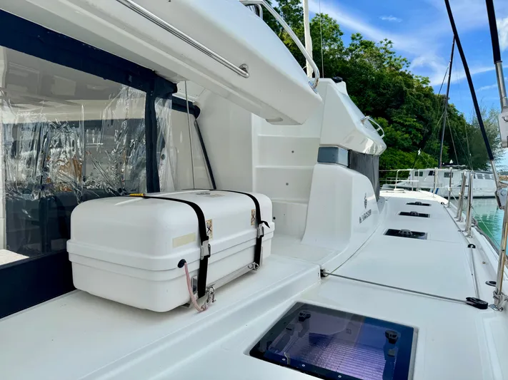 Promprang Yacht Photos Pics 2020 Lagoon 50 yacht deck with safety equipment and lush greenery in the background.