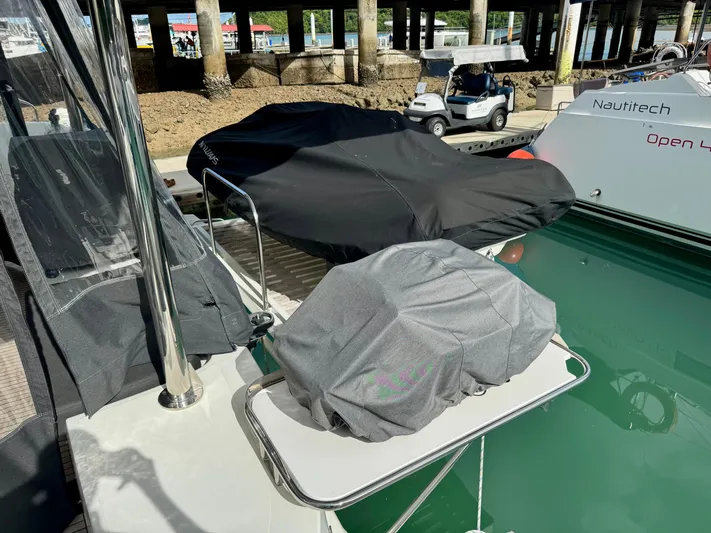 Promprang Yacht Photos Pics Covered equipment on a 2020 Lagoon 50 catamaran docked near a Nautitech Open 40.
