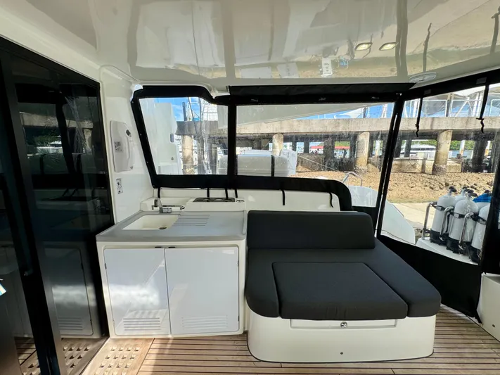 Promprang Yacht Photos Pics 2020 Lagoon 50 yacht interior with seating and kitchenette, featuring modern design and ample natural light.