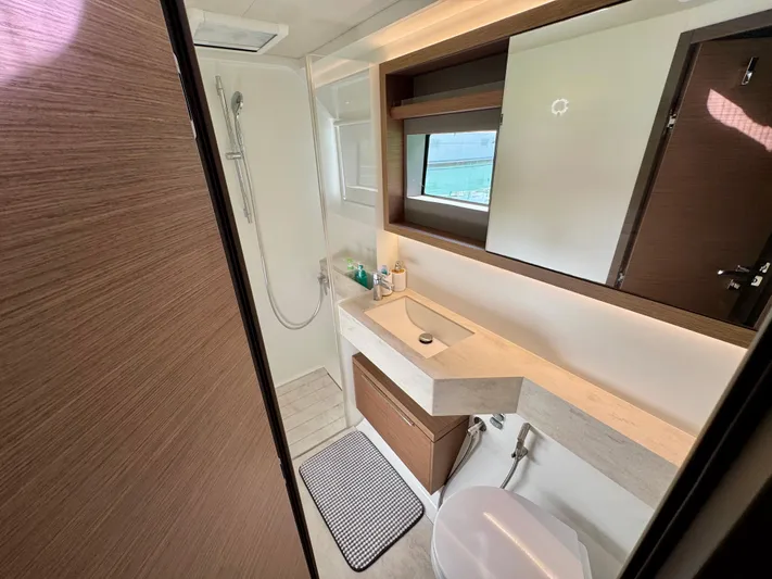 Promprang Yacht Photos Pics Modern bathroom in 2020 Lagoon 50 yacht with shower, sink, and toilet.