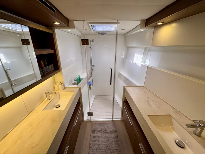 Promprang Yacht Photos Pics Luxurious bathroom in 2020 Lagoon 50 yacht with dual sinks and glass shower.