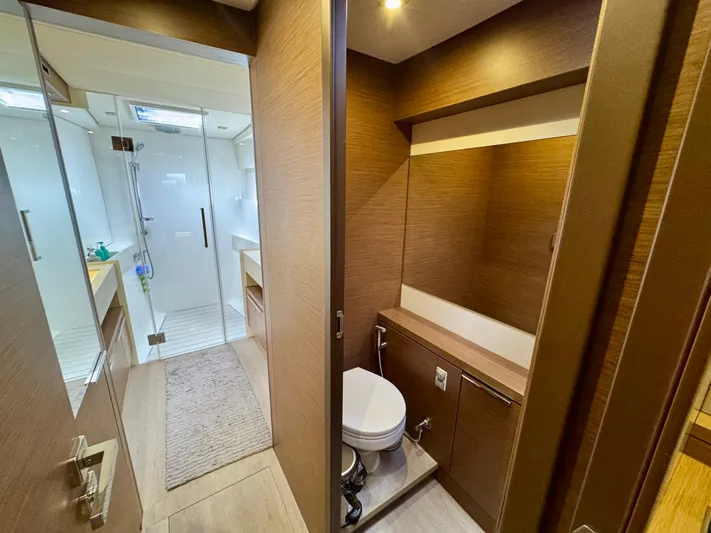 Promprang Yacht Photos Pics Modern bathroom interior on a 2020 Lagoon 50 yacht, featuring wood accents and sleek design.