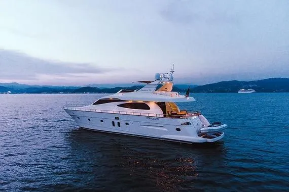  Yacht Photos Pics Luxury 2005 Canados 72 S yacht cruising at sunset on calm waters.