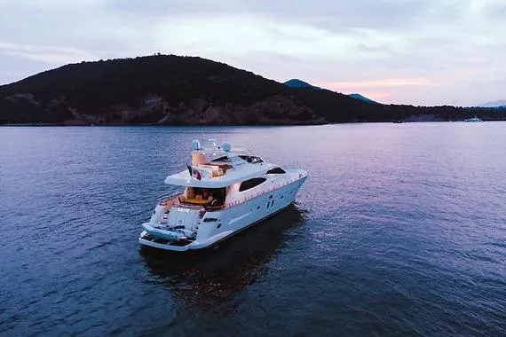  Yacht Photos Pics Luxurious 2005 Canados 72 S yacht cruising at sunset near scenic coastline.