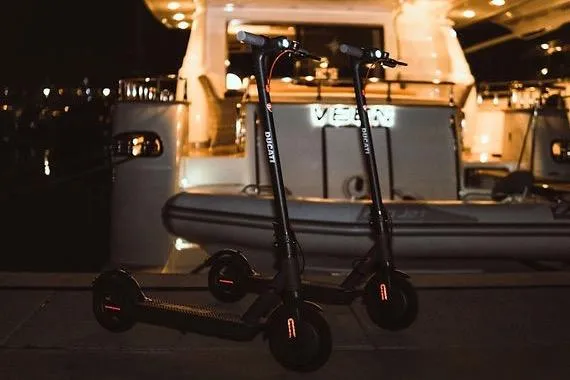  Yacht Photos Pics Two electric scooters parked in front of a 2005 Canados 72 S yacht at night.