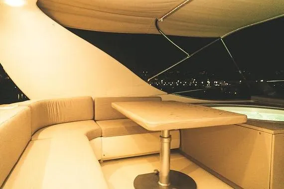  Yacht Photos Pics Luxurious 2005 Canados 72 S yacht interior with elegant seating and table at night.