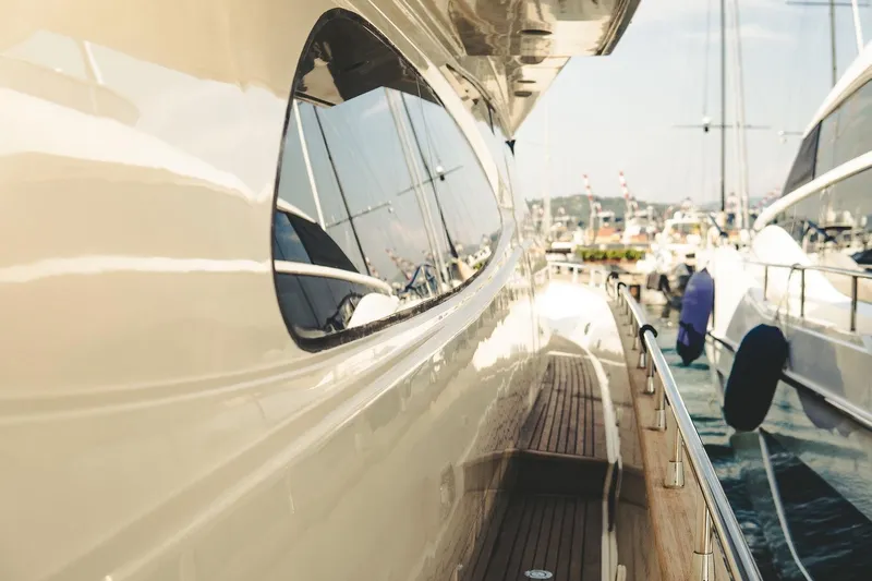  Yacht Photos Pics Side view of a 2005 Canados 72 S yacht docked at a marina.