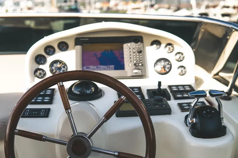  Yacht Photos Pics Cockpit of 2005 Canados 72 S yacht with steering wheel and navigation controls.