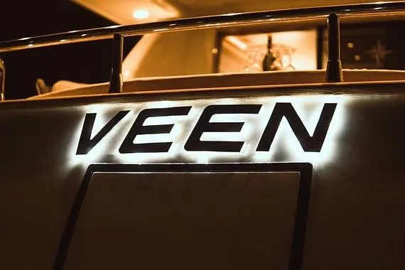  Yacht Photos Pics Illuminated "VEEN" sign on 2005 Canados 72 S yacht at night.