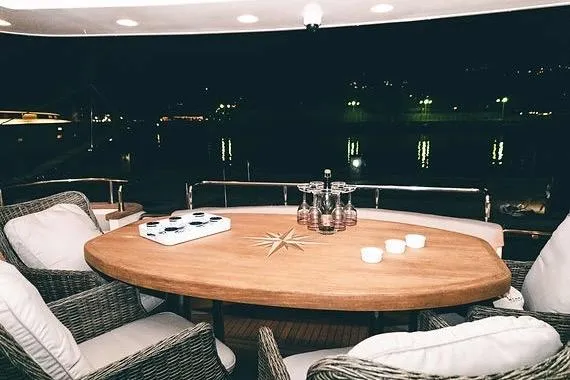  Yacht Photos Pics Luxurious 2005 Canados 72 S yacht deck with elegant dining setup at night.