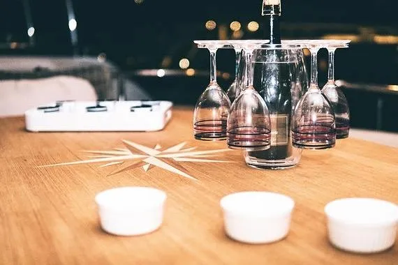  Yacht Photos Pics Wine glasses on a wooden table aboard a 2005 Canados 72 S yacht.