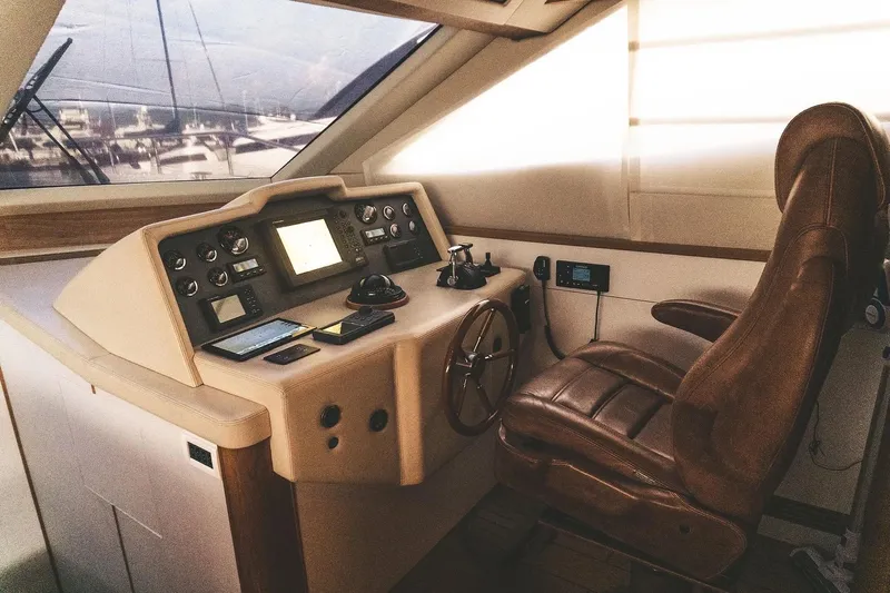  Yacht Photos Pics Luxurious helm of 2005 Canados 72 S yacht with leather captain's chair and control panel.