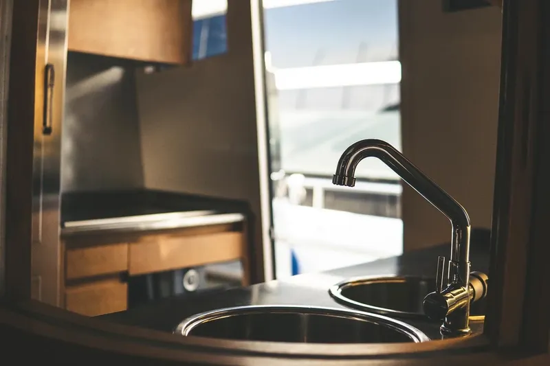  Yacht Photos Pics Luxury yacht kitchen interior with modern sink, Canados 72 S, 2005 model.