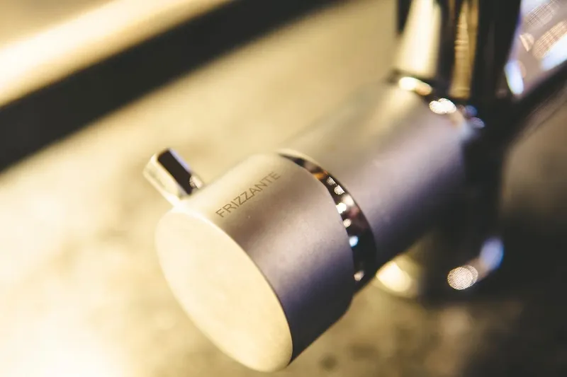  Yacht Photos Pics Close-up of a metallic faucet handle labeled "Frizzante" on a Canados 72 S yacht.