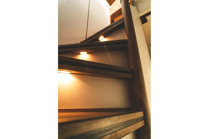  Yacht Photos Pics Wooden staircase with ambient lighting on a 2005 Canados 72 S yacht.