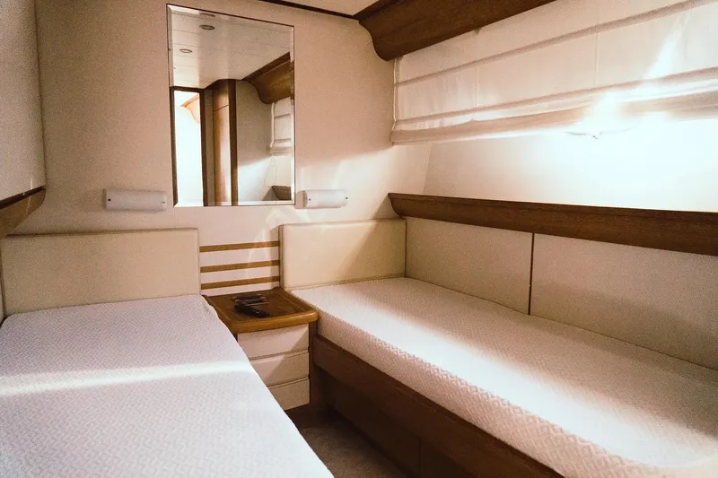  Yacht Photos Pics Interior of 2005 Canados 72 S yacht with twin beds and wooden accents.