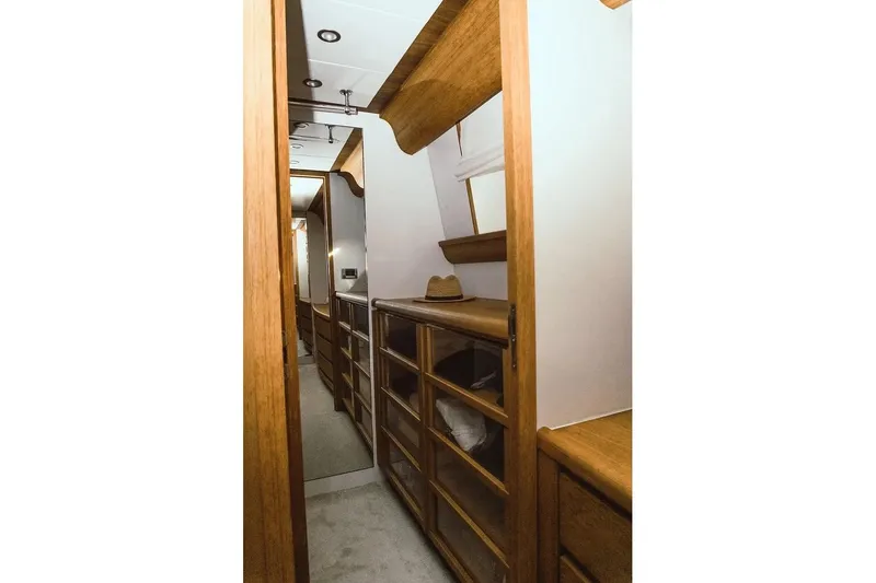  Yacht Photos Pics Luxurious wooden interior of 2005 Canados 72 S yacht, featuring elegant cabinetry and shelving.