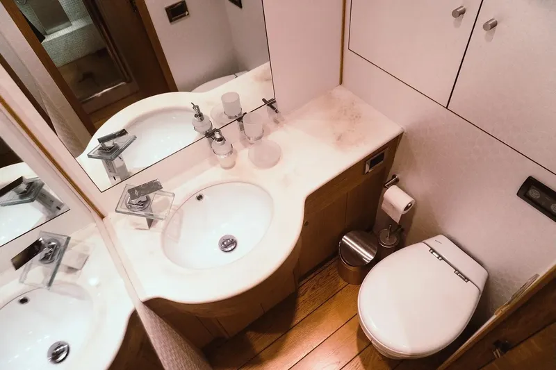  Yacht Photos Pics Luxurious bathroom in 2005 Canados 72 S yacht with modern fixtures and wooden flooring.