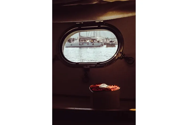  Yacht Photos Pics Porthole view from 2005 Canados 72 S yacht, overlooking marina with boats.