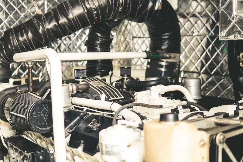  Yacht Photos Pics Engine room of a 2005 Canados 72 S yacht with visible components and piping.