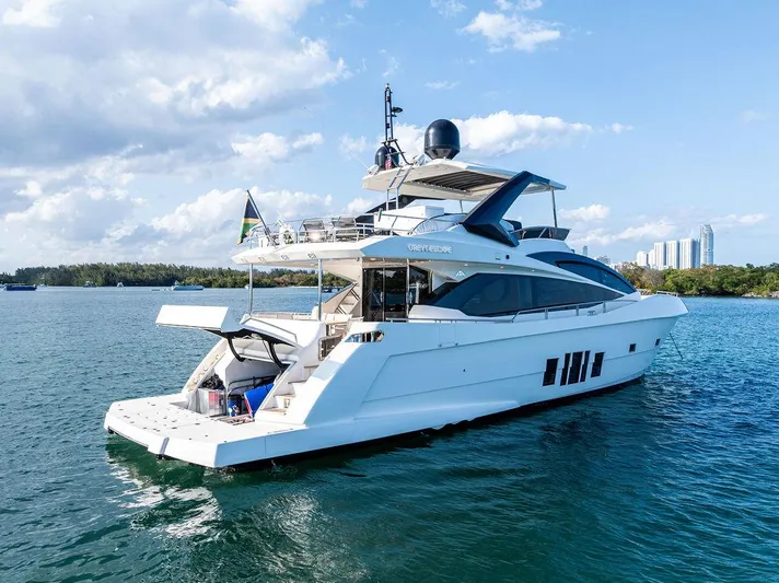 Greyt Escape Yacht Photos Pics Luxury 2013 Astondoa 72 GLX yacht cruising on a sunny day, with city skyline in background.