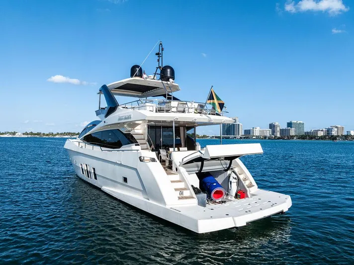 Greyt Escape Yacht Photos Pics Luxury 2013 Astondoa 72 GLX yacht on water with city skyline in background.