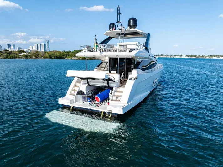 Greyt Escape Yacht Photos Pics Astondoa 72 GLX yacht cruising on blue waters, 2013 model, city skyline in background.