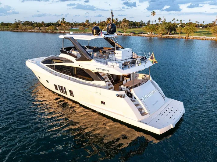 Greyt Escape Yacht Photos Pics Astondoa 72 GLX 2013 yacht cruising on serene waters at sunset.